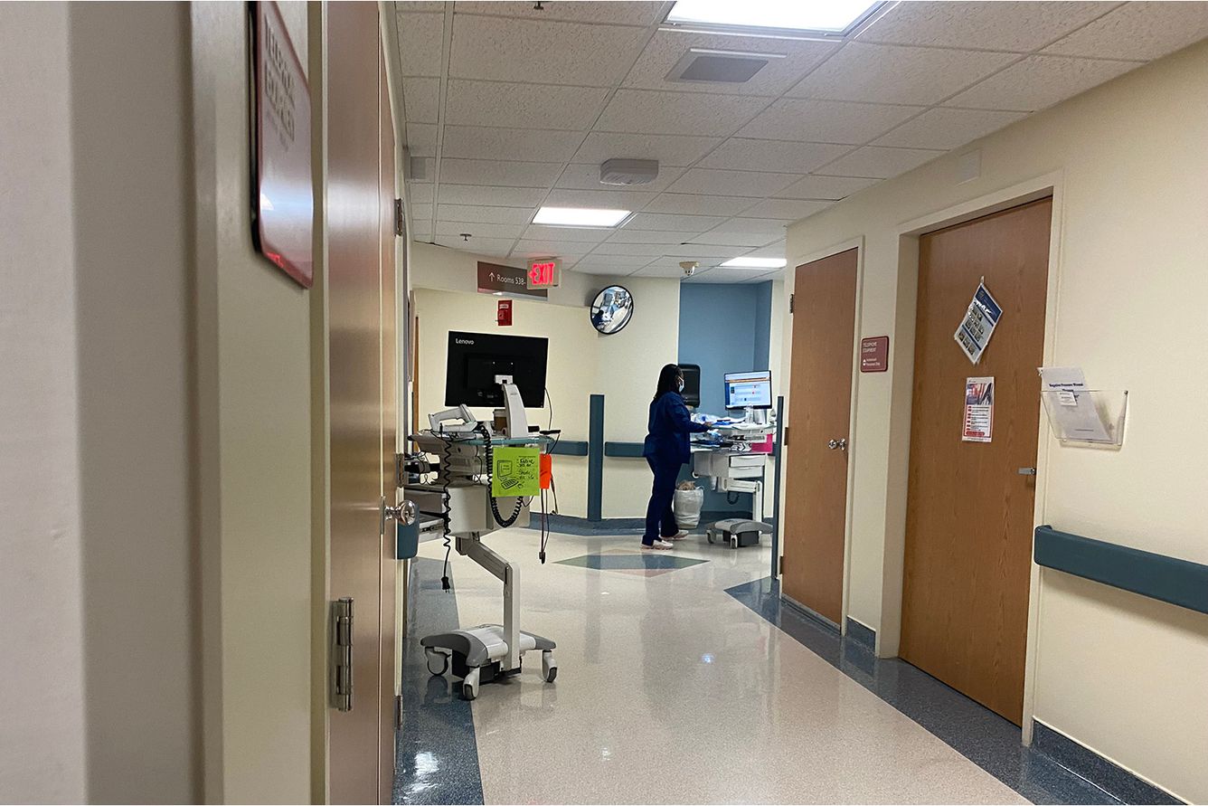 Florida hospital hallway with various medical equipment and nurse.