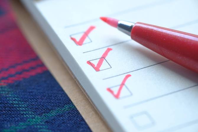 Image of a checklist with red check marks.