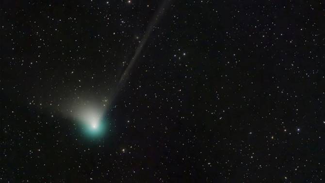 Green comet streaking through the sky