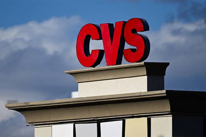 A CVS sign against a blue cloudy sky