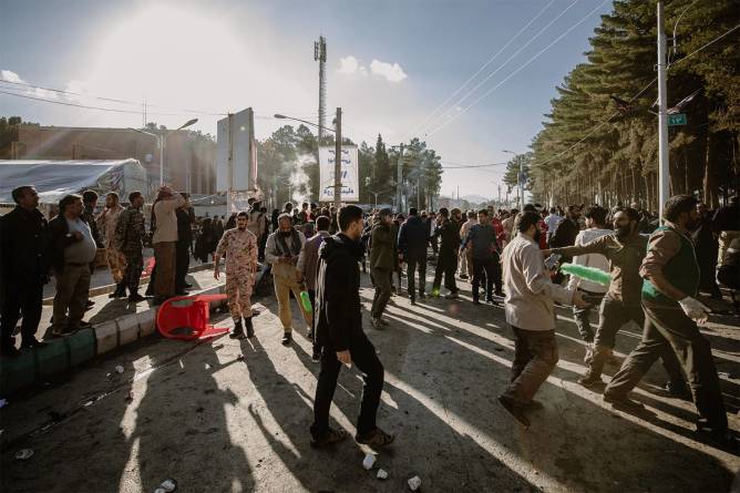 People disperse near the scene where explosions occurred on January 3, 2024, in Kerman, Iran