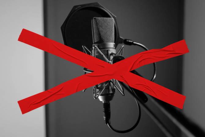 a red X over a microphone