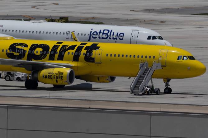 A JetBlue plane next to a Spirit Airlines plane