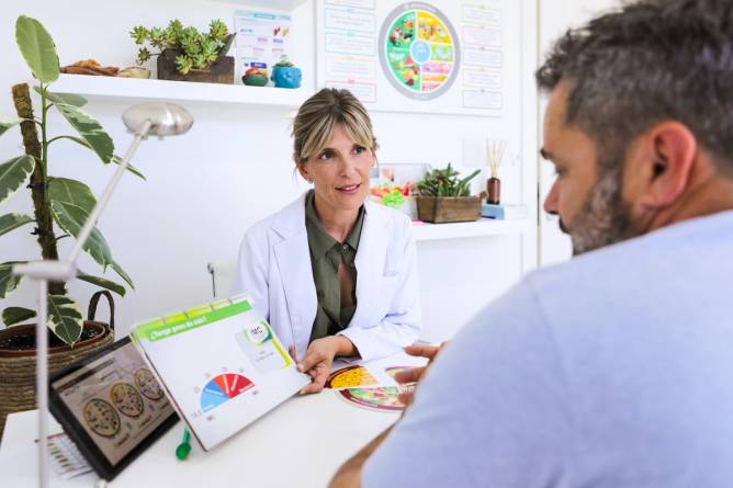 A female nutritionist consults a male patient.