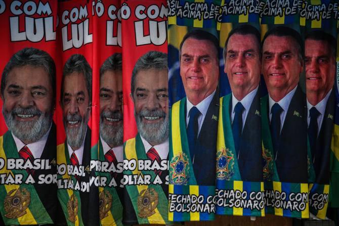 Towels with images of presidential candidates Lula da Silva and Jair Bolsonaro are displayed in a street stand to be sold in downtown Sao Paulo