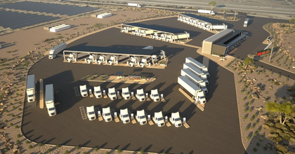 Many freight trucks parked in a parking lot next a solar panel field