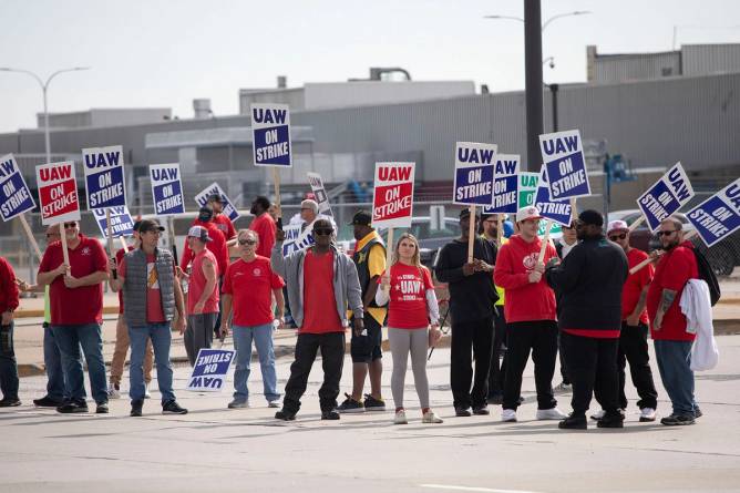 Striking UAW workers outside an auto plant