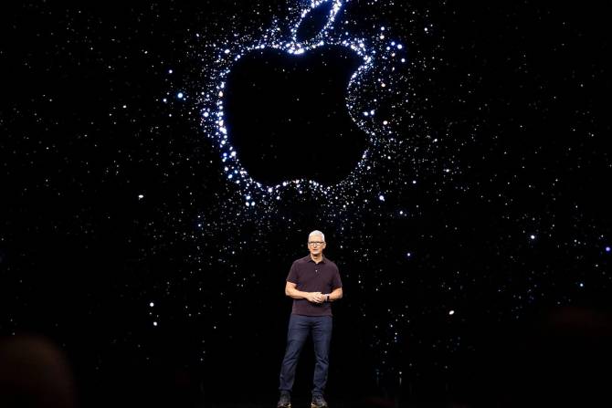 Apple CEO in front of Apple logo