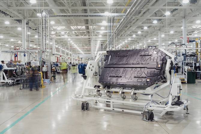 image showing a Rivian battery pack being wheeled through a facility