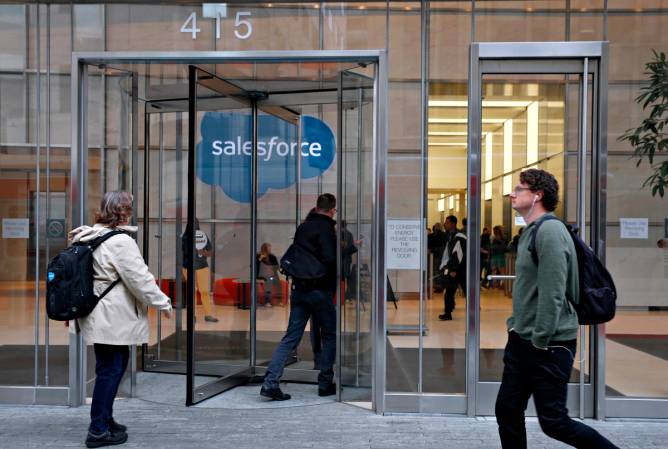 People walking into a Salesforce corporate office from the outside.