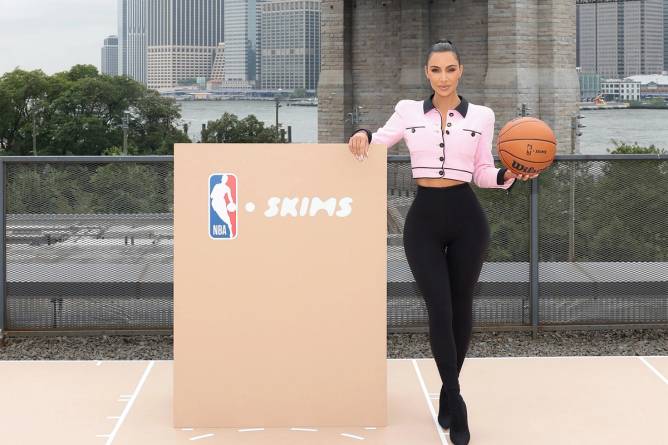 Kim Kardashian posing at the announcement of Skims partnership with the NBA