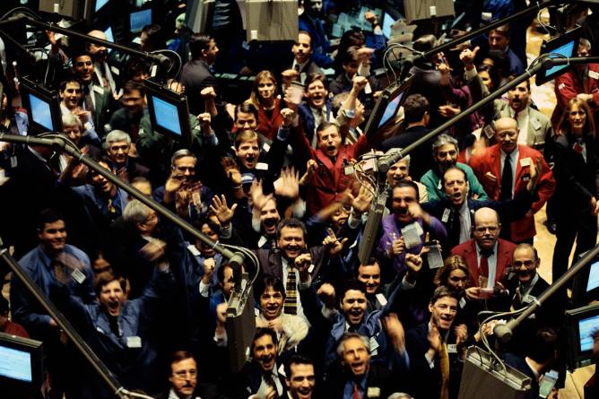 Traders celebrate on the stock exchange floor