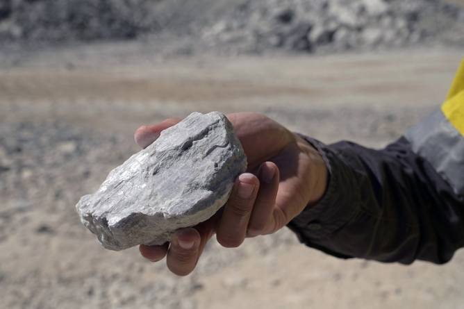 A person holding a lithium rich rock