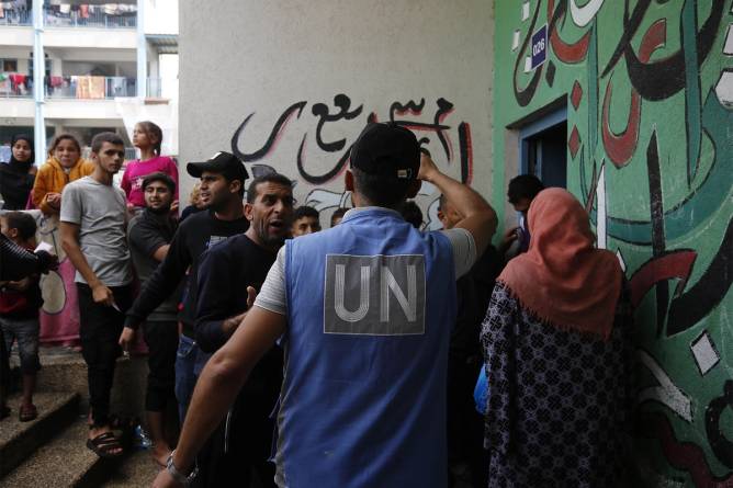 United Nations officers work to distribute aid to Palestinians in Gaza