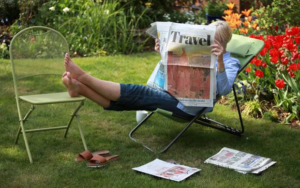Someone reading the travel section of a paper