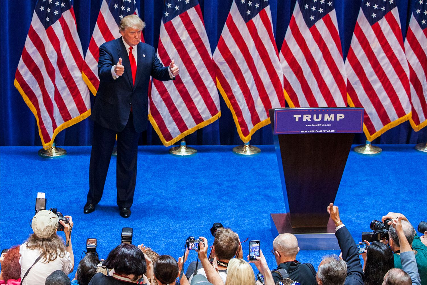 Donald Trump gives a crowd of people with cameras and their phones out a thumbs up after announcing his candidacy for the U.S. presidency.