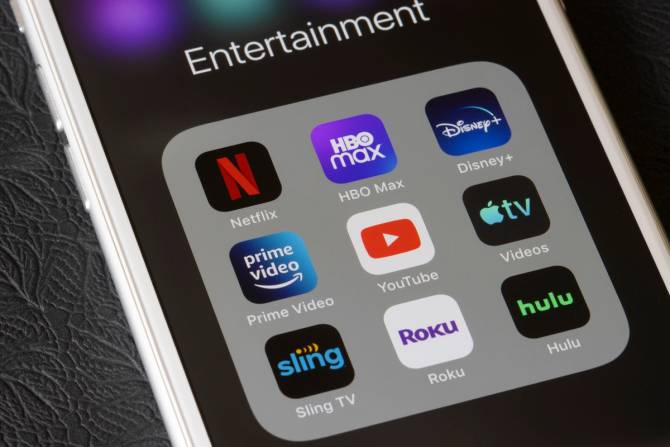 a phone screen featuring several streaming apps, including Hulu, Netflix, and HBO Max