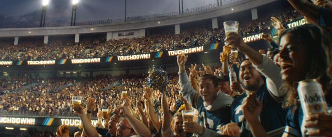 fans at a football game drinking Modelo