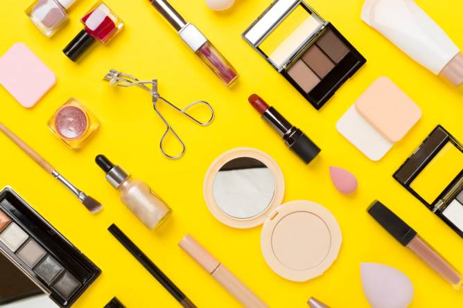 Makeup products on yellow background