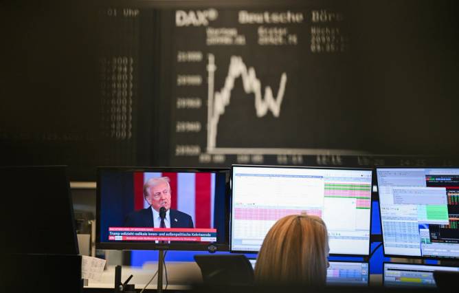 A stock trader watches President Trump's inauguration at her desk