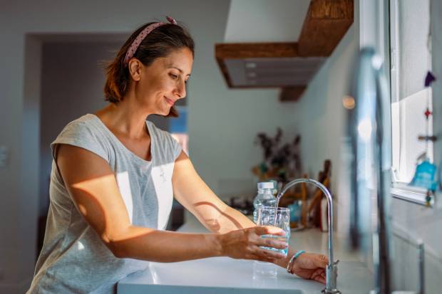 Woman pouring water fluoride