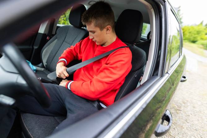 Teenage boy in car