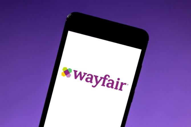 The Wayfair logo on a smartphone screen.