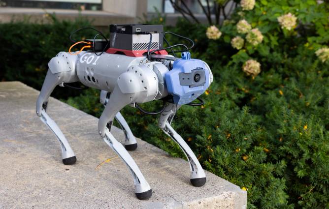 A robot dog sitting on a ledge.