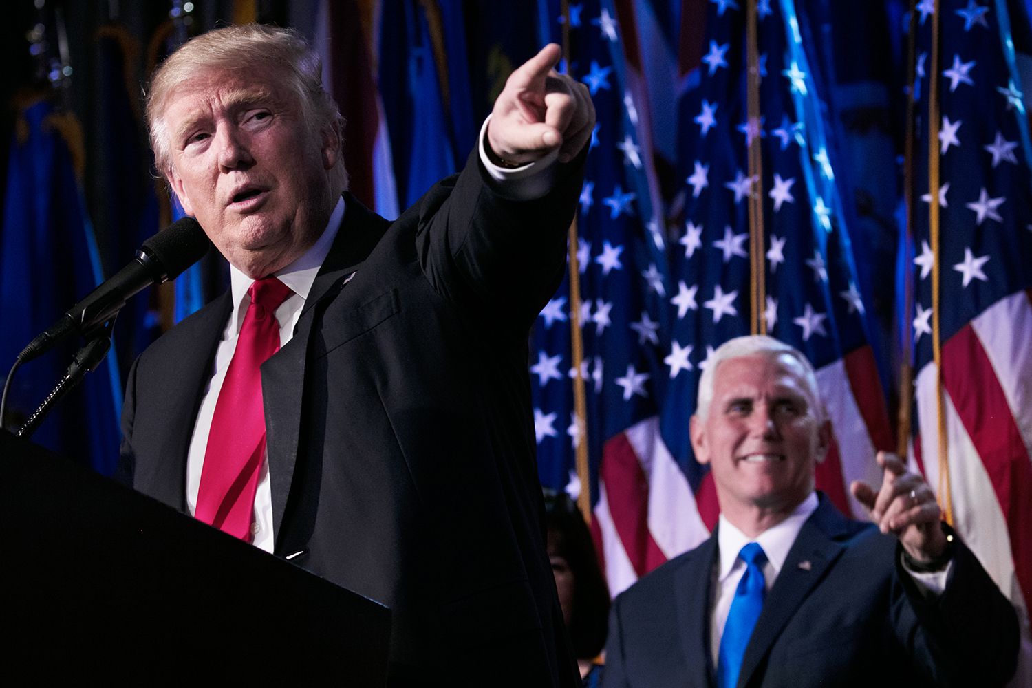 President-elect Donald J Trump and Vice President-elect Mike Pence in front of American flags.