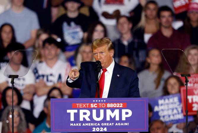 Trump gesturing at a campaign event 