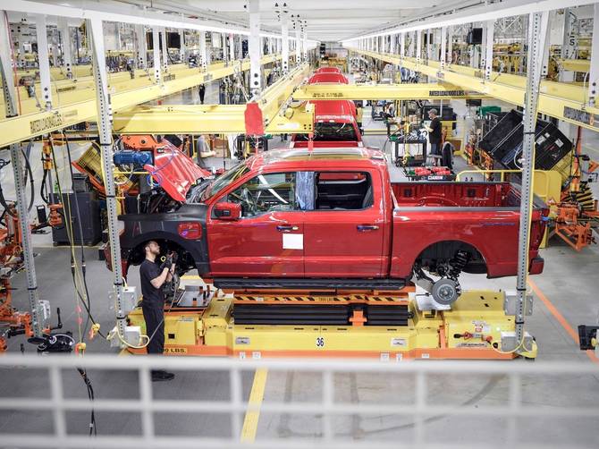 image of a ford factory worker assembling an f-150 lightning