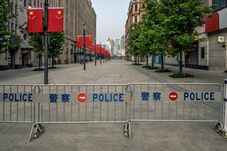 An empty plaza with police blockades in China.