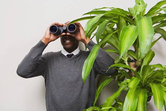 business man looking through binoculars