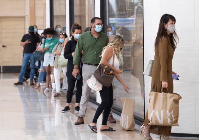 Shoppers wait in line at Zara.