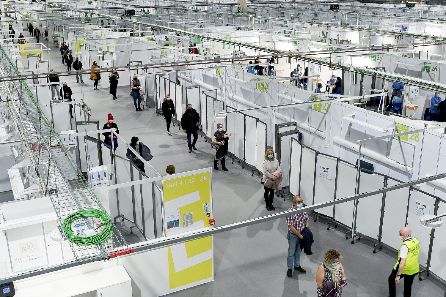 Staff and key workers queue before receiving the coronavirus vaccine.