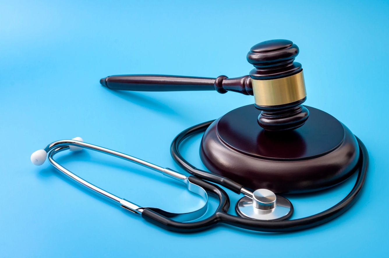 gavel and stethoscope isolated on blue background
