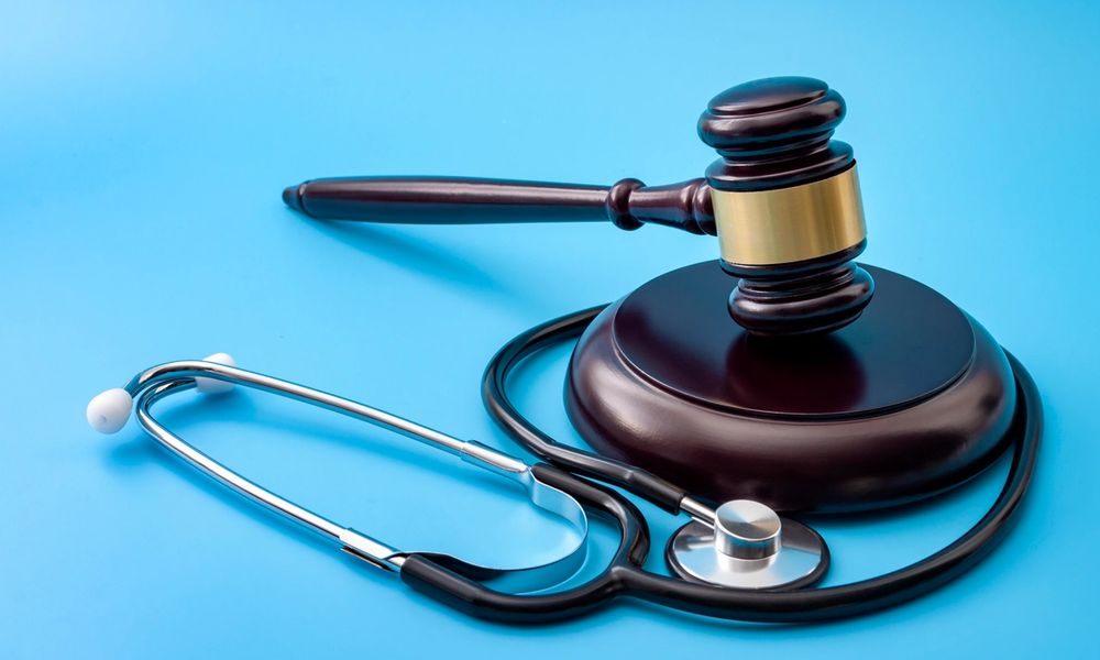 gavel and stethoscope isolated on blue background