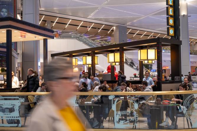 Travelers dine in a terminal of Newark International Airport.