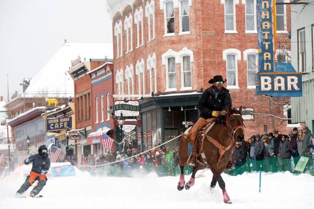 A rider pulls a skier down Harrison Avenue during the 76th annual Leadville Ski Joring weekend competition on March 3, 2024 in Leadville, Colorado.