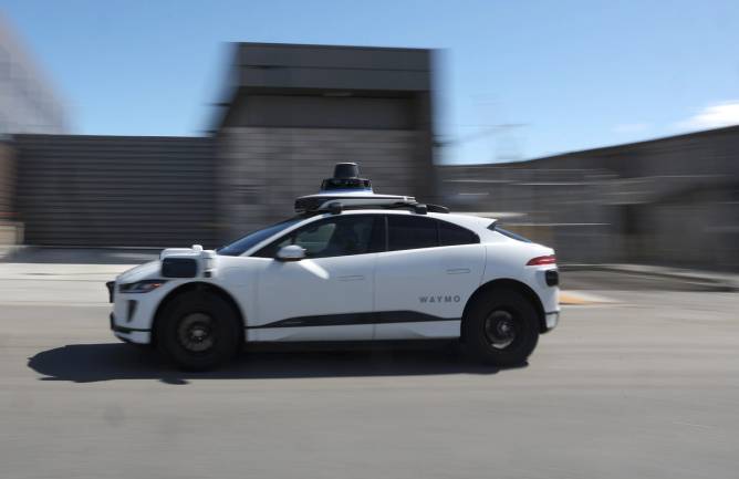 Image of a white Waymo vehicle