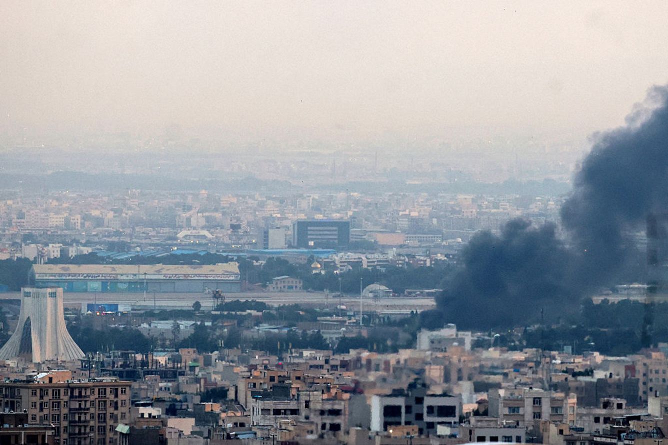 Smoke billows from a site near the Azadi Tower (L) in central Tehran, as fighting between Israel and Iran continues on June 16, 2025. Israel and Iran traded deadly fire on June 16 in their most intense confrontation in history, fuelling fears of a drawn-out conflict that could engulf the Middle East. 
