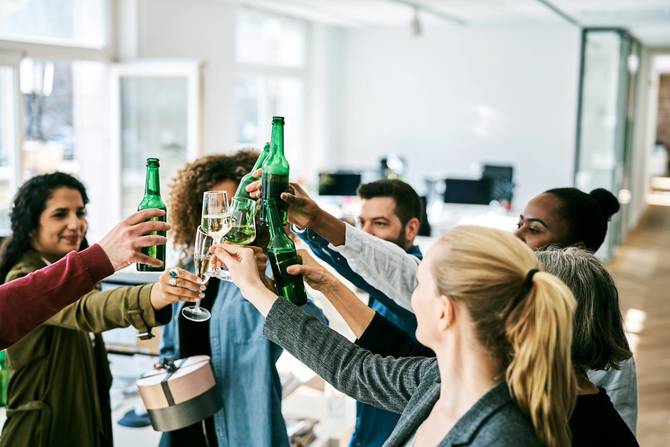 business professionals toasting drinks in the office