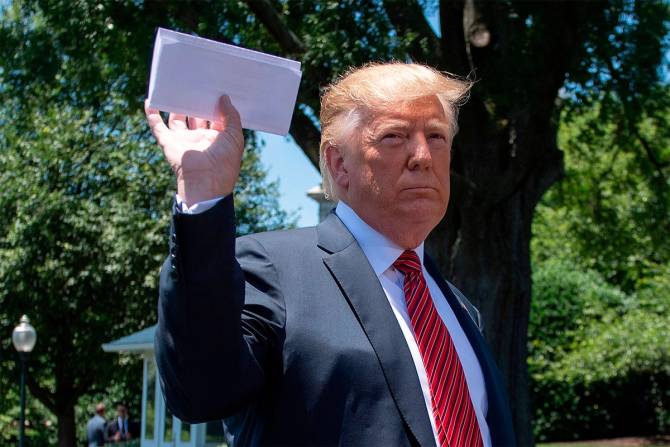 Former President Trump holding up documents