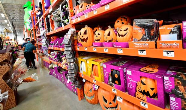 People shop for Halloween items at a home improvement retailer store