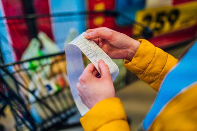 Consumer checking a grocery bill in store