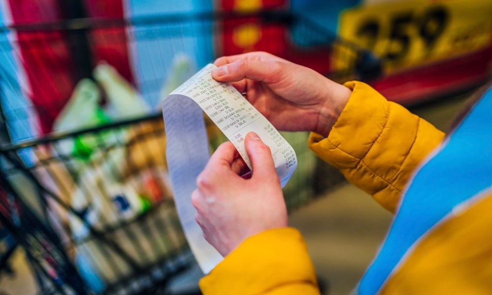 Consumer checking a grocery bill in store
