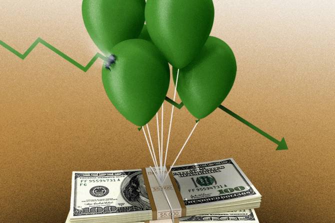 A balloon that's carrying money is popped, signaling lower inflation