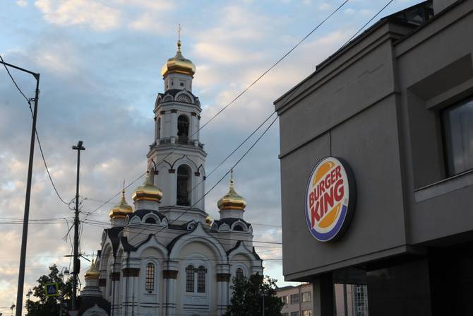 The Great Zlatoust church or Maximilian church stands as a backdrop against 'Burger King' logo