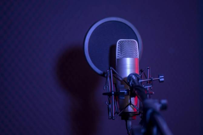 a microphone on a purple/blue background