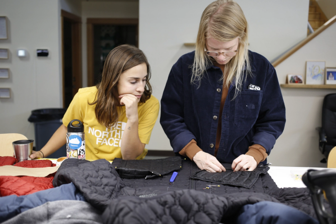 Two people looking over North Face products and fabrics 
